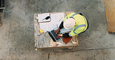 Buy stock photo Typing, laptop and above of man on construction site for planning, building permit and compliance. Architecture, documents and person on computer for renovation, online blueprint and infrastructure
