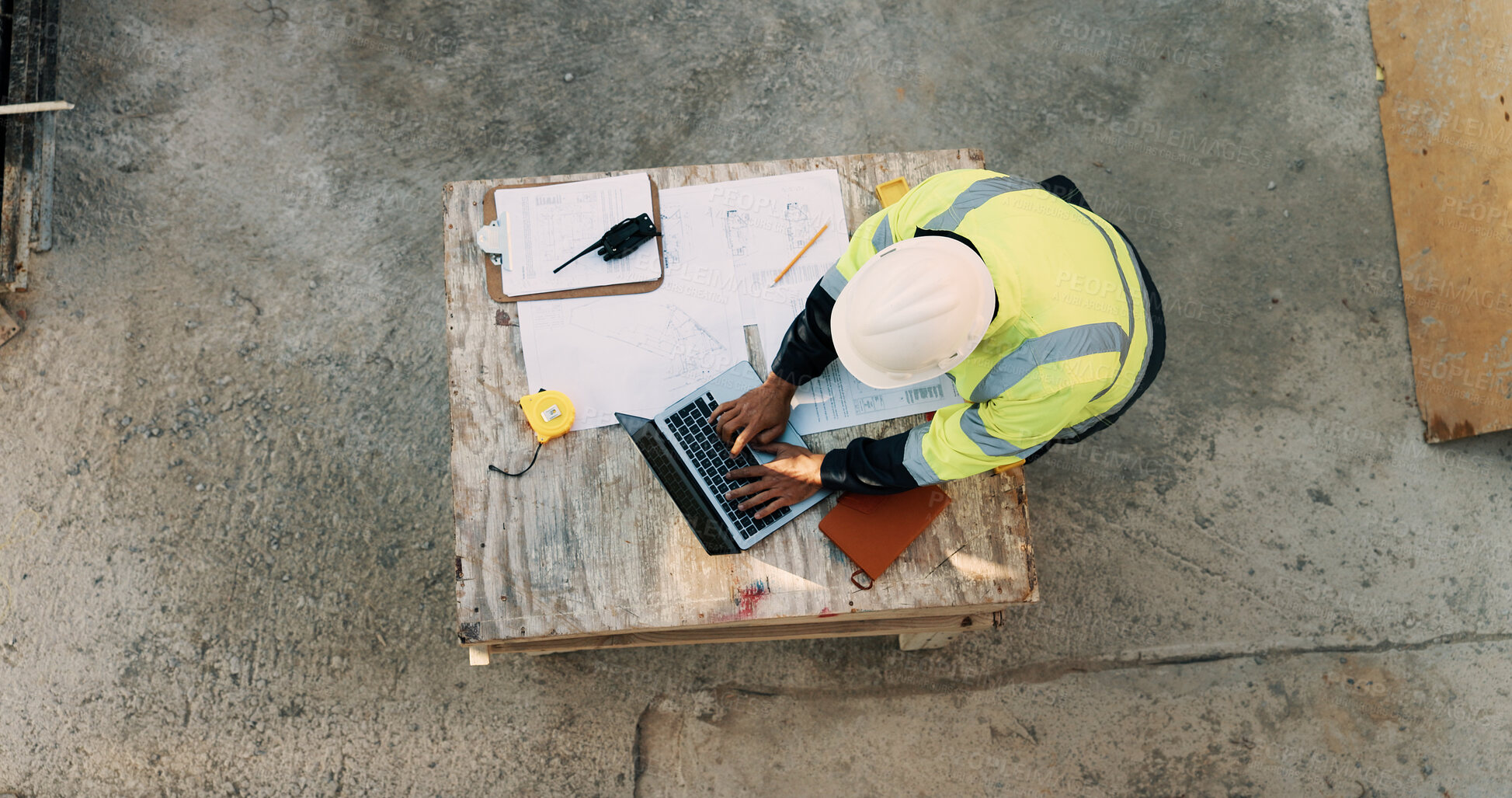 Buy stock photo Typing, laptop and above of man on construction site for planning, building permit and compliance. Architecture, documents and person on computer for renovation, online blueprint and infrastructure