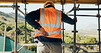 Construction, injury and man with back pain for accident, stress and overworked at building site. Architecture, engineering and person with pressure for fibromyalgia, muscle sprain and hurt outdoor