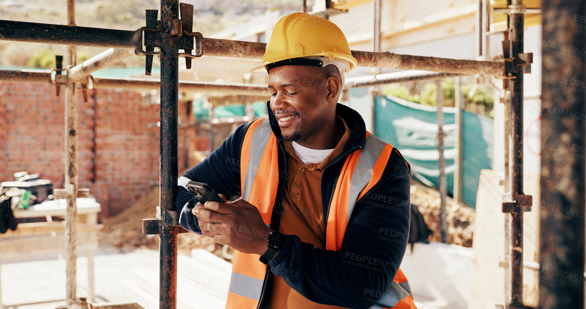 Buy stock photo Cellphone, black man and construction worker on site with texting for feedback on building infrastructure. Phone, communication and civil engineer with email for review on renovation or development.
