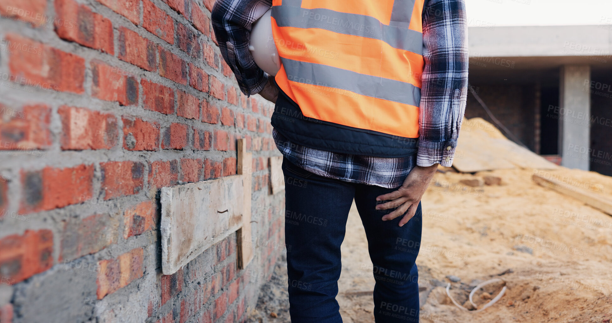 Buy stock photo Construction, injury and man with leg pain for accident, stress and overworked at building site. Architecture, engineering and back of person with muscle fatigue for fibromyalgia, sprain and hurt