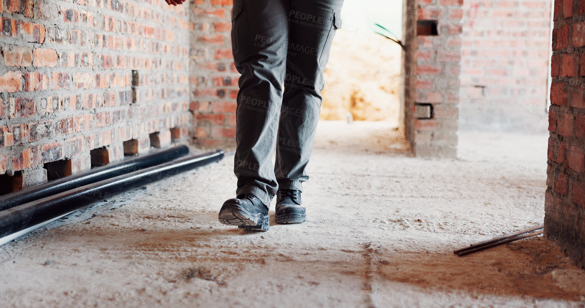 Buy stock photo Walking, building and feet of person on construction site for planning, infrastructure and inspection. Architecture, civil engineer and legs of worker for property, renovation and remodeling project