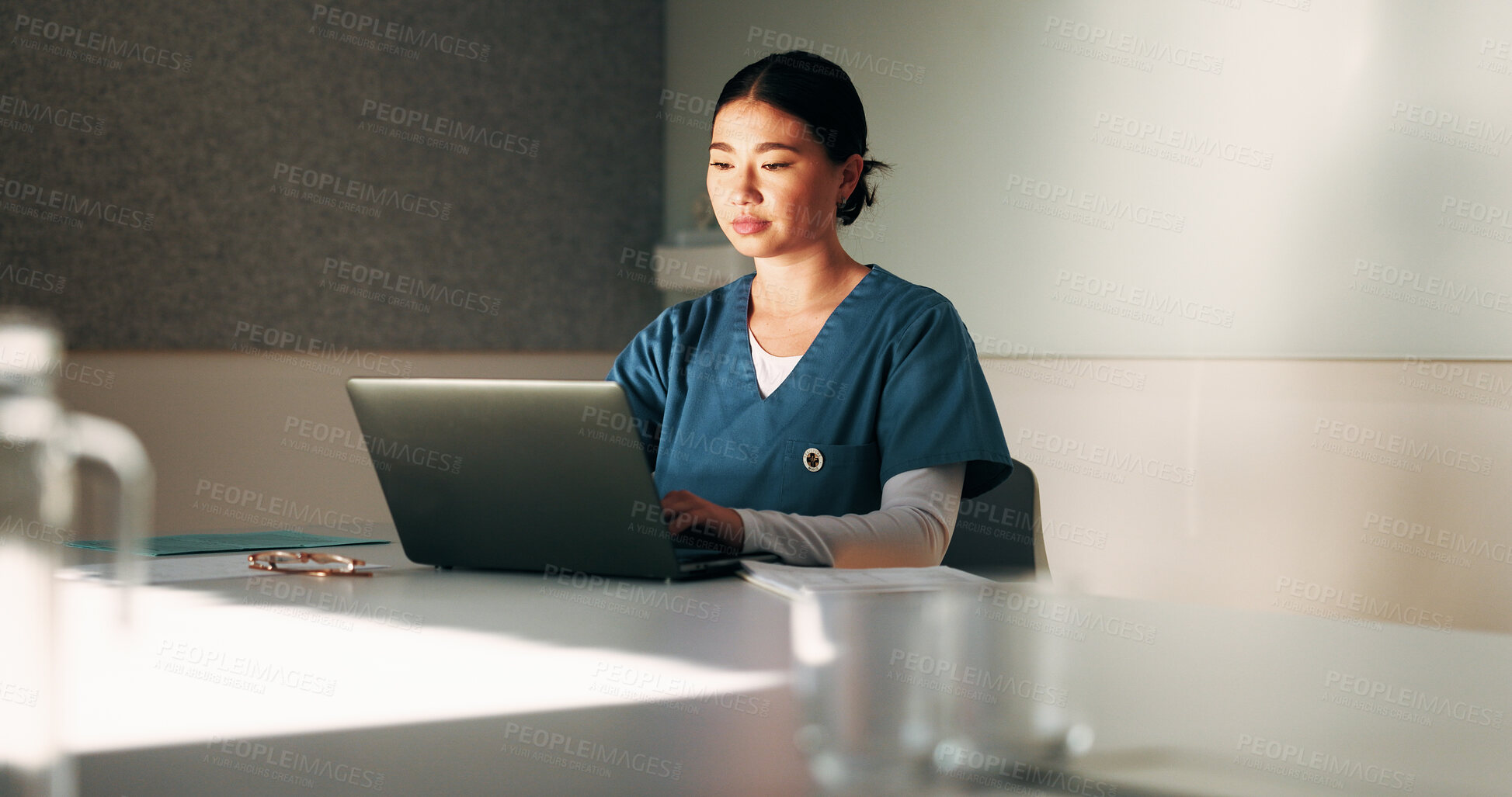Buy stock photo Nurse, typing and woman with laptop in clinic, admin and reading medical records on website. Healthcare specialist, online and Asian person with tech for test results, info or research in hospital