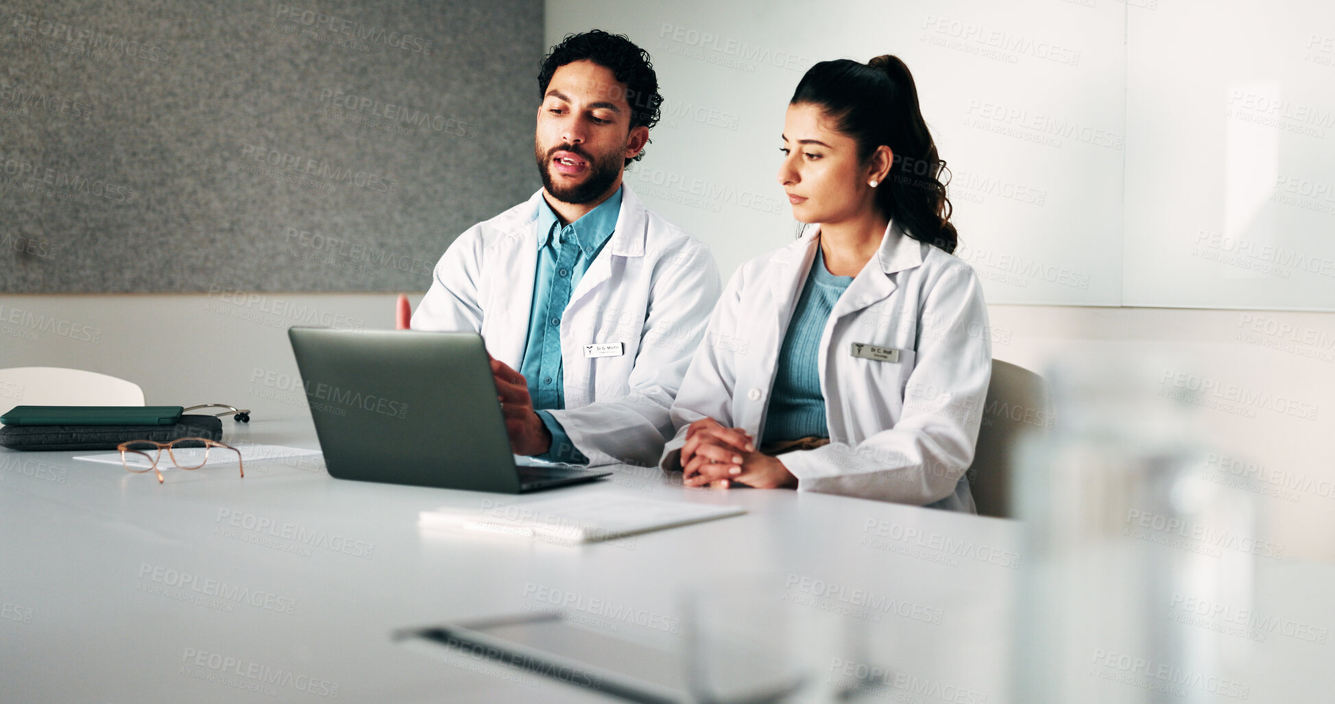 Buy stock photo Doctors, team and laptop with planning at hospital in boardroom, review and discussion for healthcare. People, medical professional and meeting with computer, feedback or services at wellness clinic