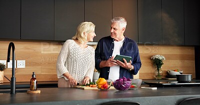 Buy stock photo Tablet, happy and senior couple in kitchen with online recipe for dinner, meal or healthy food in home. Digital technology, smile and elderly man with woman for cooking instructions on app in house.