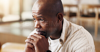 Buy stock photo Home, thinking and sad man with depression, mental health and regret past mistake in living room alone. Black person, sorrow and despair in lounge with reflection, stress and contemplation for guilt.