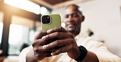Buy stock photo Hands, phone and man in home with mobile connection for social media, messaging app and search. Black person, technology and scroll online in lounge to relax, networking and notification on sofa