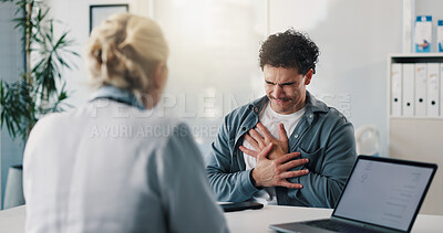 Buy stock photo Doctor, chest pain and consultation with man for healthcare, hypertension symptoms or diagnosis. Cardiology, medical worker and patient with sore heart, illness or assessment with laptop in hospital