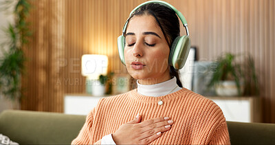 Buy stock photo Woman, breathing and headphones on couch for meditation, spiritual healing and audio for zen. Female person, relax or eyes closed in home with calm music, inner peace and inhale guidance for wellness
