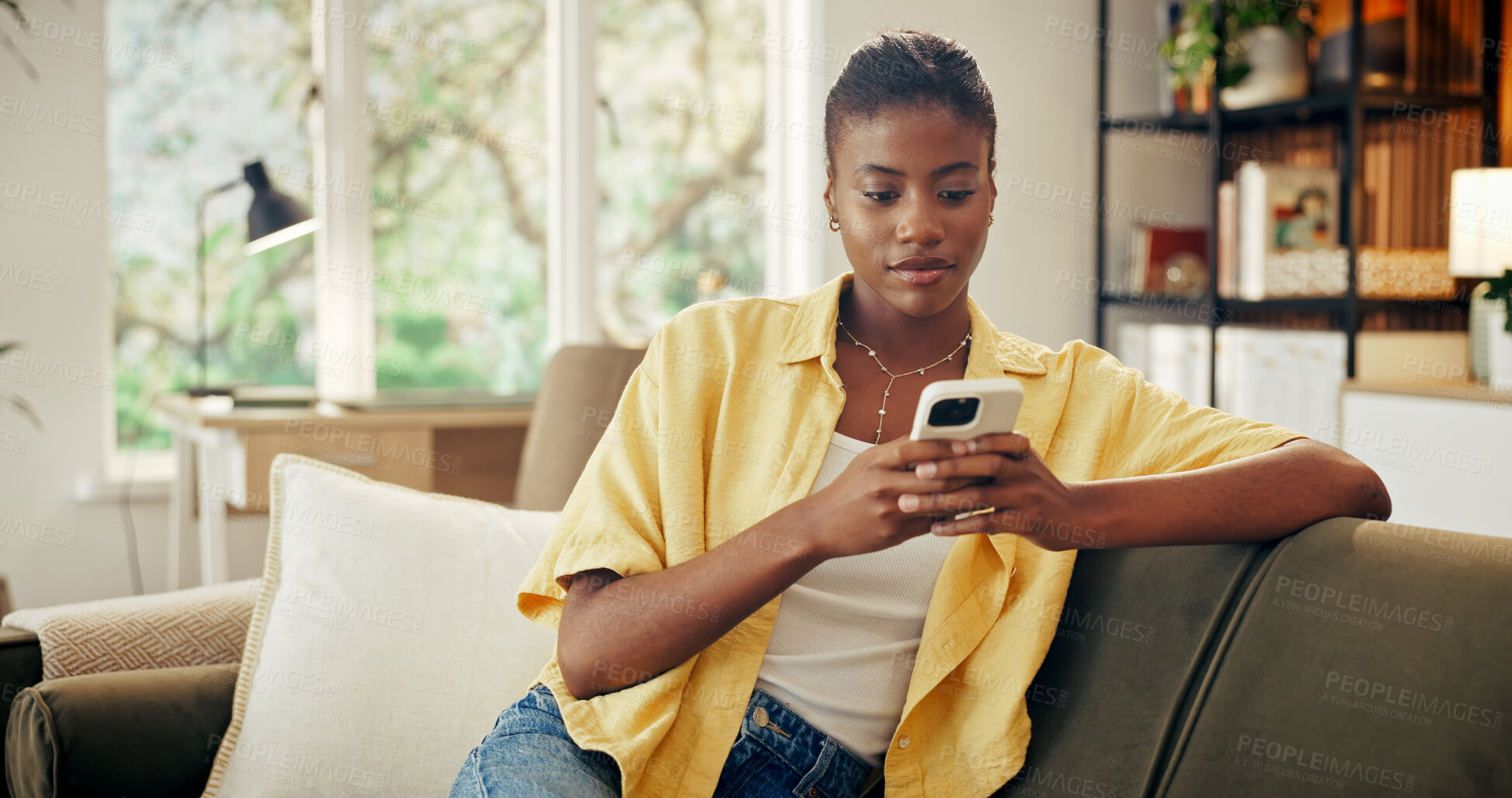 Buy stock photo Digital, message and black woman in house with phone, online chat and post reaction on social media. Typing, contact and person with technology, texting update or communication on mobile app.