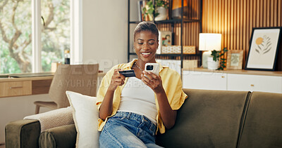 Buy stock photo Phone, black woman and credit card in home for online shopping, internet banking or investment. Sofa, debit and happy person with mobile payment, budget or money transfer to savings account in lounge