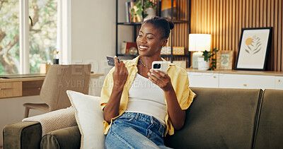 Buy stock photo Phone, black woman and credit card in home for finance, internet banking or smile with investment. Sofa, debit and person with mobile payment, online shopping or money transfer to savings account