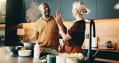 Buy stock photo Kitchen, high five and mature couple for cooking, cuisine and meal prep for dinner or lunch. Home, culinary and man with woman with success for new recipe, ingredients and interracial relationship