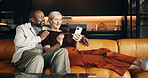 Mature, couple and credit card in home with phone, plan holiday or payment of flight ticket for travel. Happy, interracial marriage and people on sofa with online banking, tech and vacation expenses.