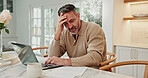 Man, laptop and stress in home with documents for finance, inflation budget or mistake in kitchen. Mature, male person or checking invoice with expensive bill for debt review or tax increase in house