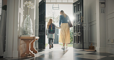 Buy stock photo Mom, leaving and girl in home with backpack, support and back to school for education. Woman, walking or front door with daughter for commute, morning routine and bonding together for learning