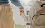 Mother, holding hands and child leaving with backpack, support and back to school for education. Woman, walk or front door with daughter for commute, morning routine and bonding together for learning