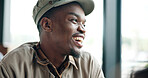Morning, thinking and black man in coffee shop for laughing, funny memory and positive mood. Happy, restaurant and person with reflection, thoughtful and remember joke, humor and break on weekend