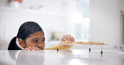 Buy stock photo Sneaky, kitchen and child by counter with cookies, sweet treats or dessert for unhealthy snack. Smile, naughty and girl with secret, stealing and taking biscuits for eating, hungry or craving in home