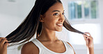 Smile, woman and touch in bathroom for haircare, beauty and healthy shine for keratin treatment. Happy, female person and check hair in home for texture, frizz control and cosmetics for scalp hygiene