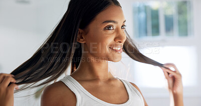 Buy stock photo Smile, woman and touch in bathroom for haircare, beauty and healthy shine for keratin treatment. Happy, female person and check hair in home for texture, frizz control and cosmetics for scalp hygiene