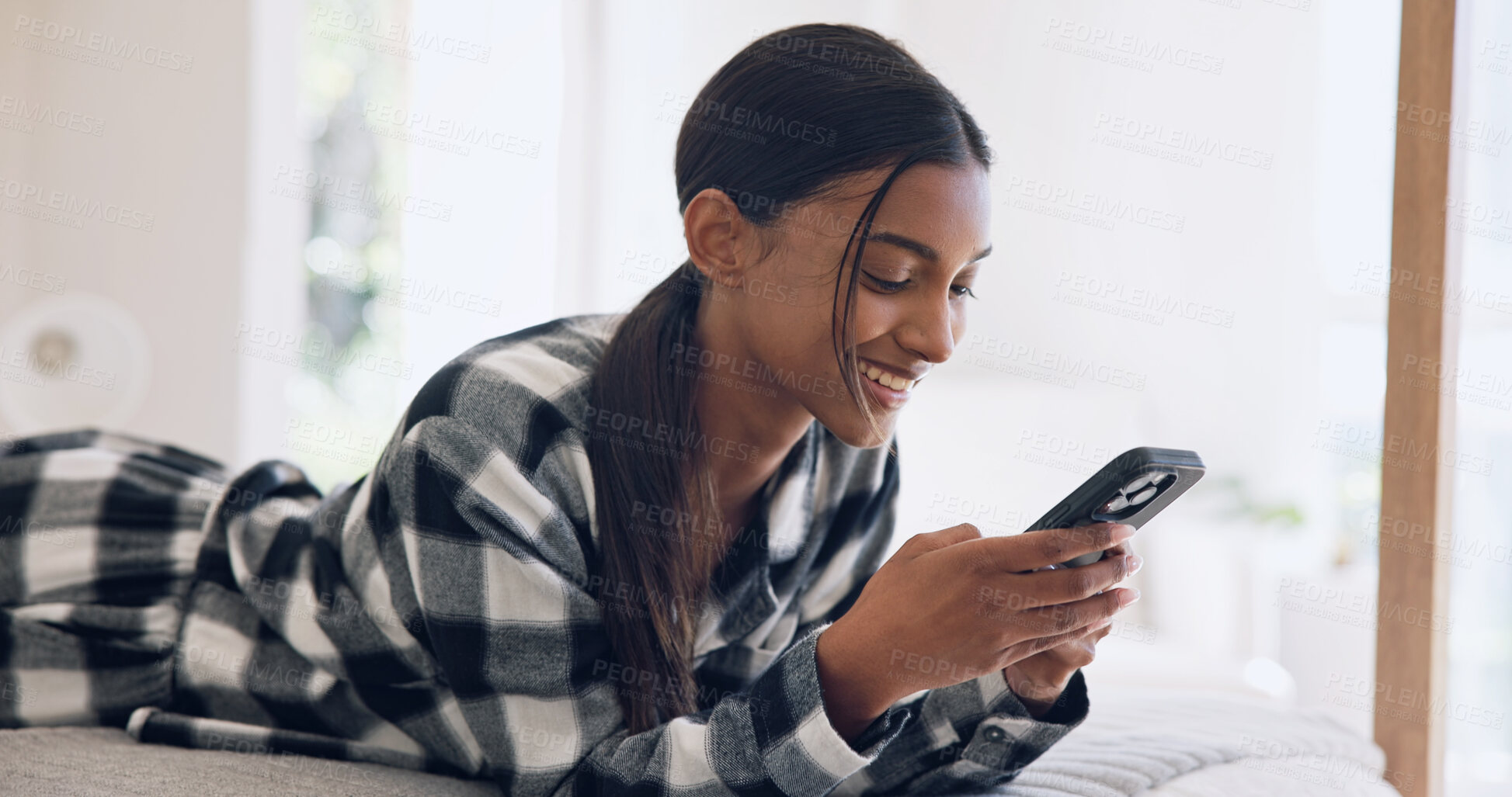 Buy stock photo Woman, smile and phone on bed with typing, text message and social media scroll or internet browsing. Person, relax and digital tech in bedroom for reading ebook, dating site or comfortable in home