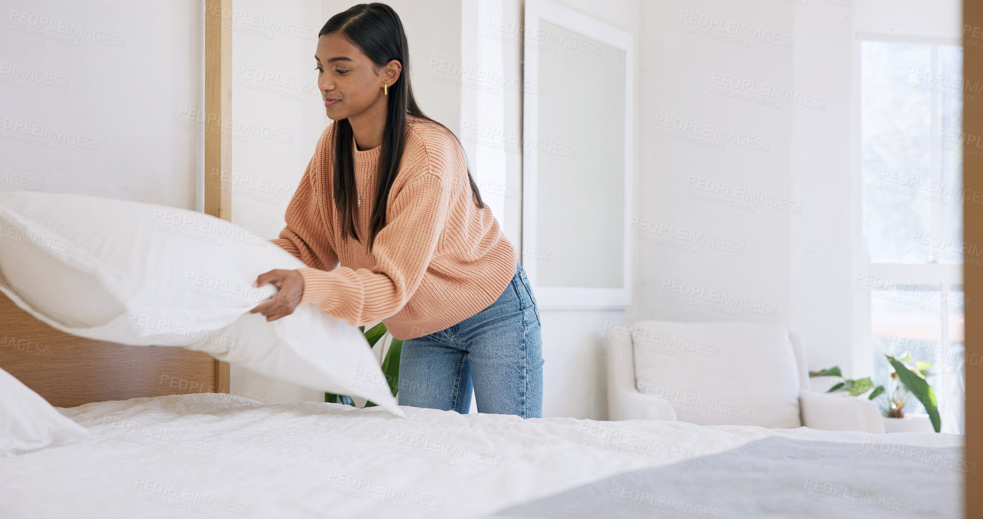 Buy stock photo Tidy, morning and woman with pillow in bedroom for cleaning, maintenance and housework. Neat, happy and person with daily routine for hygiene, housekeeping and straighten bed to organize in home