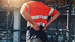 Construction, injury and man with back pain for accident, stress and tension at building site. Architecture, engineering and person with pressure for fibromyalgia, muscle sprain and overworked