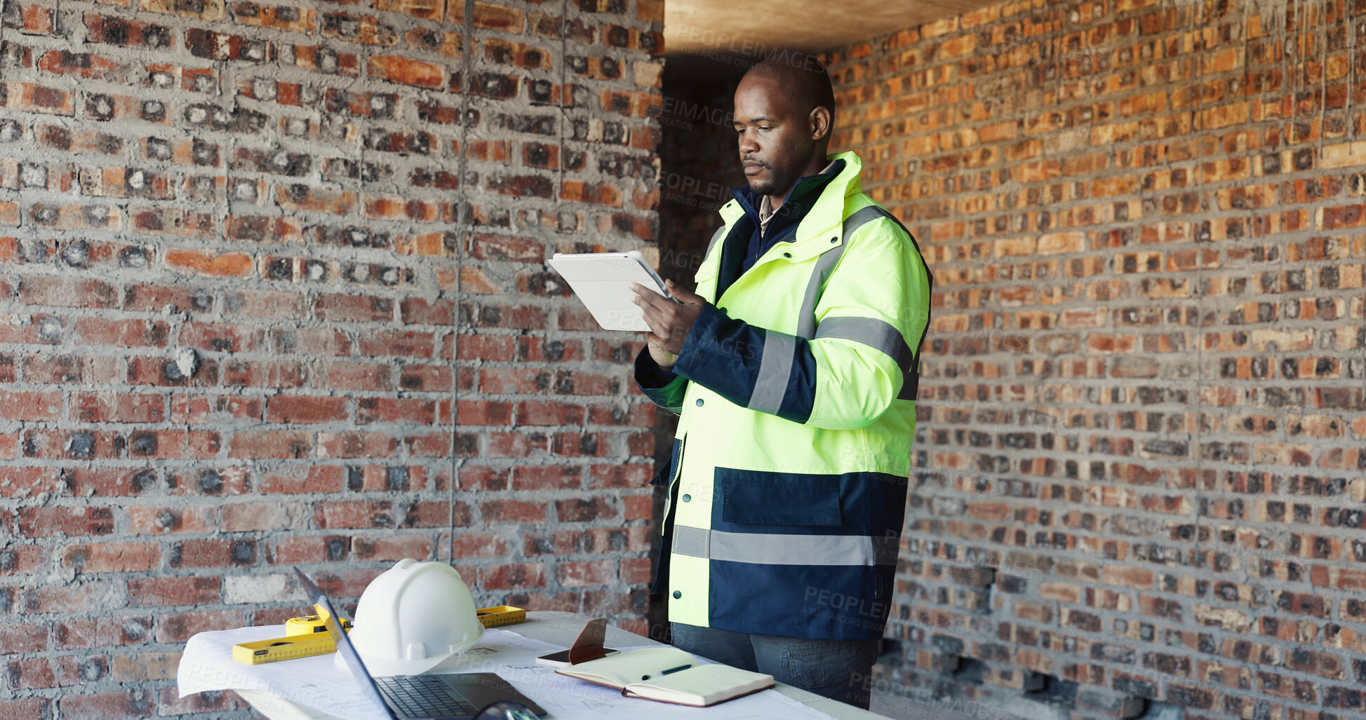 Buy stock photo Engineer, reading and black man tablet for construction, inspection and research for renovation. Male person, review and tech at site for architecture, building expansion and information for project