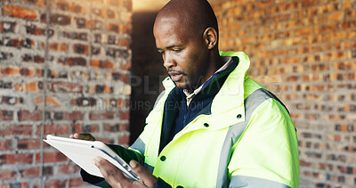 Buy stock photo Serious, engineer and black man with tablet for construction, research and report for renovation. Person, reading and digital at site for architecture, building expansion and information for project