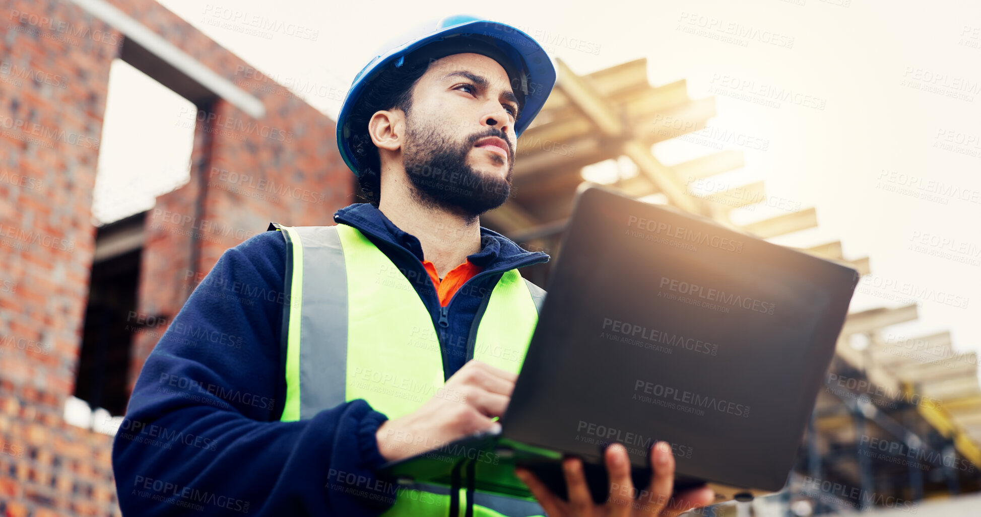 Buy stock photo Architect, man or inspection with laptop on construction site for building safety or security. Low angle, contractor or civil engineer with computer for architecture plan, project or infrastructure