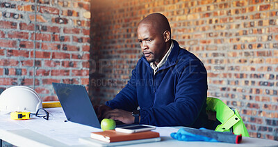 Buy stock photo Typing, architect and black man with laptop for construction project, building or property expansion. Engineer, computer or serious person in office for real estate development or architecture design
