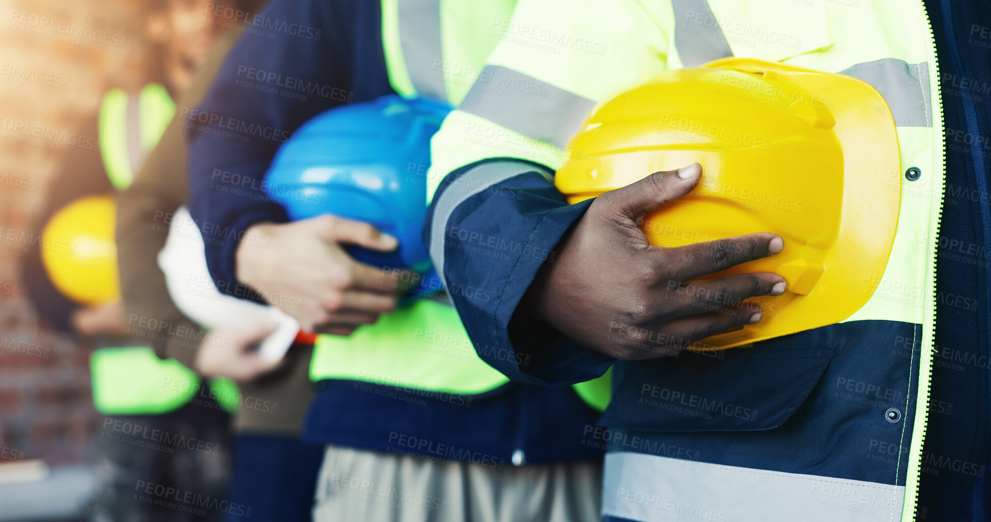 Buy stock photo Construction, hands and row of people with helmet for safety, site inspection or industry protocol. Line, workers and waiting with hard hat for team briefing, workplace compliance and maintenance ppe