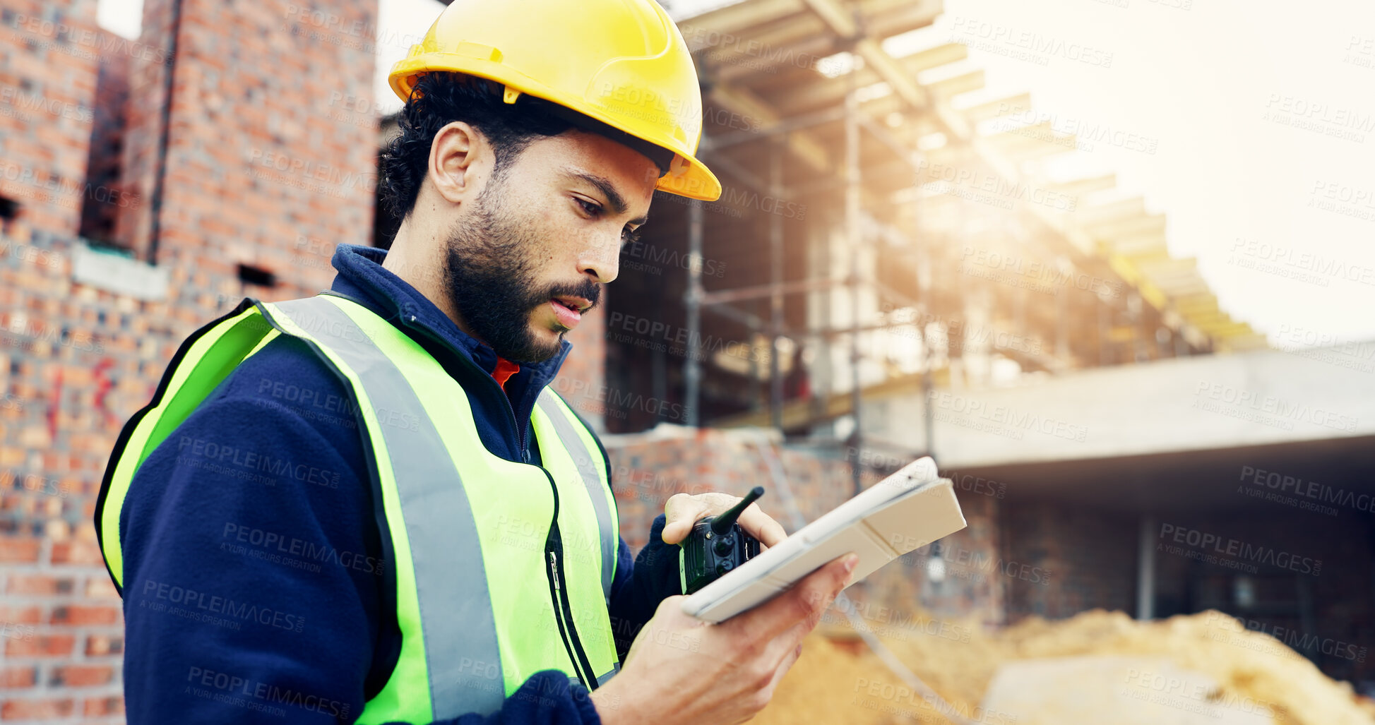 Buy stock photo Construction site, engineering and man with radio, tablet for online schedule and feedback for inspection. Person, architecture and employee with internet, website info or tech for renovation and app