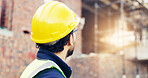 Architect, man and helmet with building inspection on construction site for safety regulations. Male person, contractor or civil engineer checking infrastructure for architecture project or security