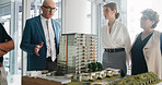 Property development, meeting and team in agency with model, feedback or discussion in design review. Building, people or architects with prototype, structure plan or group evaluation on investment.