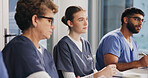 Woman, nurse and group in hospital for meeting, update procedure and planning for healthcare. Attentive, team and medical department in workplace for shift schedule, task delegation and workshop