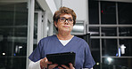Night, tablet and thinking with nurse woman in hospital for healthcare, medical review or planning. App, glasses and vision with person in dark clinic for diagnosis, digital report or results