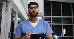 Night, tablet and thinking with nurse man in hospital for healthcare, medical review or study. App, help and research with thoughtful person in dark clinic for internship or residency as student