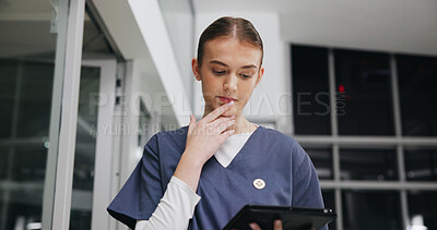 Buy stock photo Reading, tablet and thinking with nurse woman in hospital at night for healthcare or medical review. App, report and research with thoughtful student in dark clinic for internship or residency