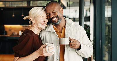Buy stock photo Happy, couple and relax in home with coffee, love and partner affection for weekend break. Smile, interracial mature people and laugh at house with drinks, admiration and romance for bonding together