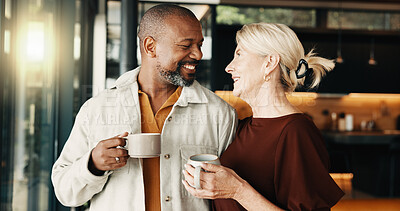 Buy stock photo Happy, mature couple and home with coffee, love and partner affection for weekend break. Smile, interracial people and relax in living room with beverage, admiration and romance for bonding together