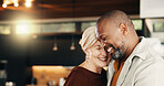 Interracial couple, hug and man with smile, reunion and love or commitment for relationship. Happy, mature people and security with embrace, romance and space with bonding and partner in home