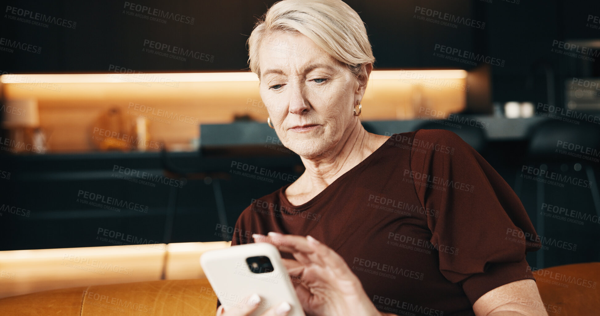Buy stock photo Serious, woman and texting with phone in home, online and communication with contact on social media. Typing, message and mature person with mobile, internet connection and reading chat on website 