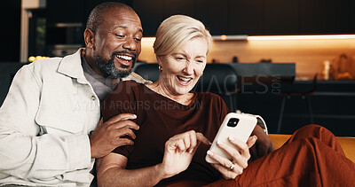 Buy stock photo Interracial couple, phone and laughing with hug for joke, mobile app and funny conversation in home. Mature people, communication and streaming entertainment on tech for humor on social media