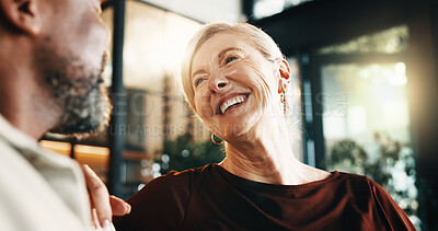 Buy stock photo Smile, woman and relax in home with man, love and partner affection for weekend break in lounge. Happy, interracial mature couple and laughing at house with admiration, romance and bonding together