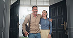 Smile, couple and entry at front door with hug, partner affection and arrival from work. Happy, people and walking in doorway with romantic embrace, homecoming and bonding together for return home