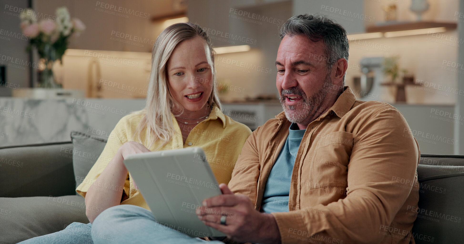Buy stock photo Couple, relax and conversation in house with tablet, browsing social media or digital app for news. Married, mature man and woman on sofa with tech, reading article or discussion for bonding together