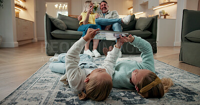 Buy stock photo Children, sisters and play in home with tablet, learning game and bonding with parents supervision. Happy, girls and siblings typing on floor with tech, entertainment and online gaming for education.