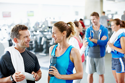 Buy stock photo Shot of two young friends having a discussion while at the gym